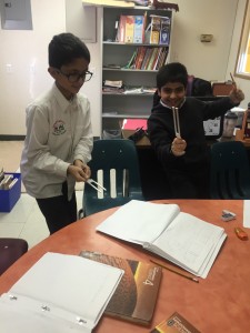 Shifaan and Mohammed test out the tuning forks for the first time to learn about pitch.