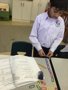 Ahmad is measuring the length of his desks with links. 