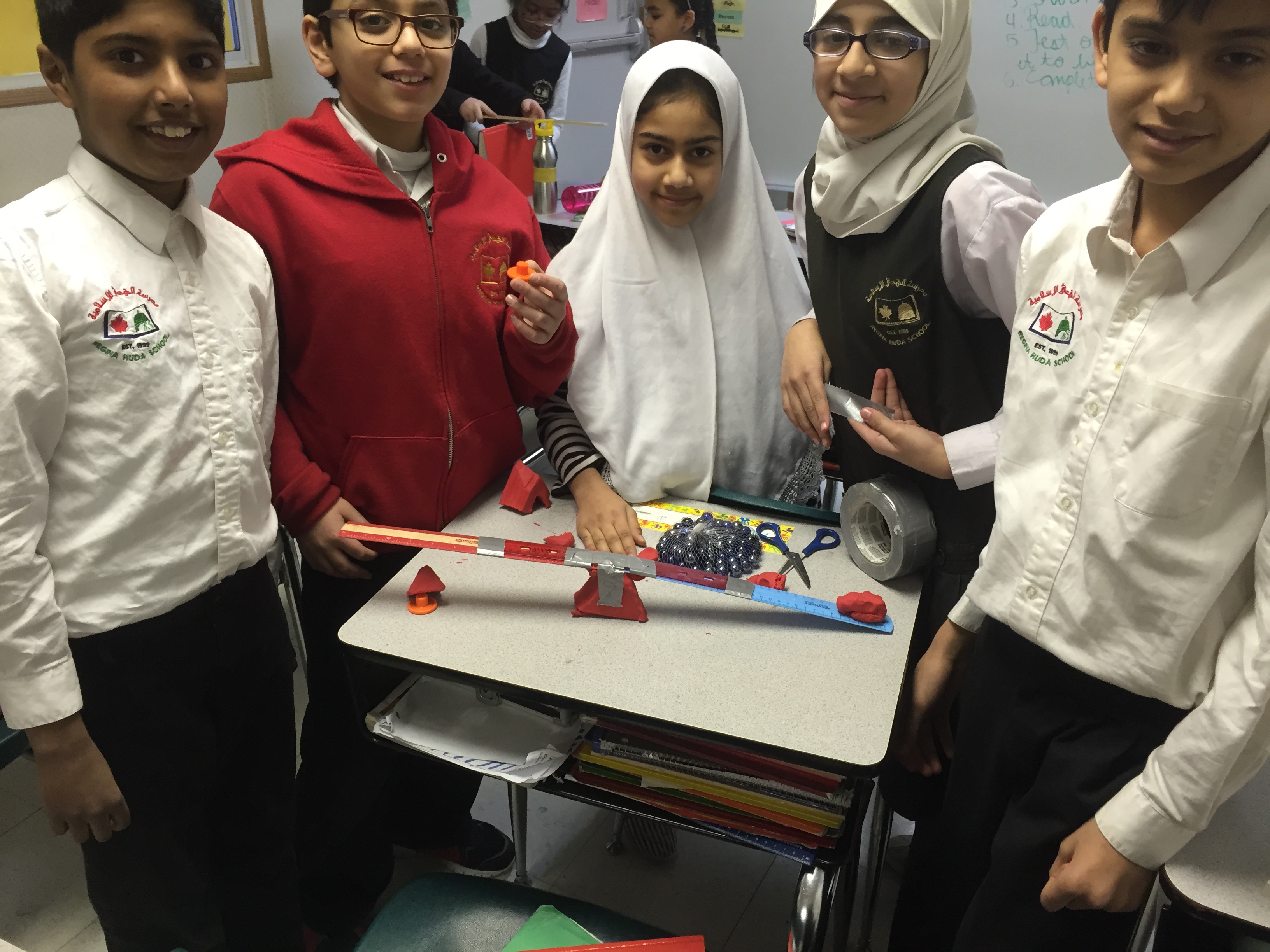 Shayaan, Usman, Rimsha, Nusaiba and Abdullah are building a "lever" in science.